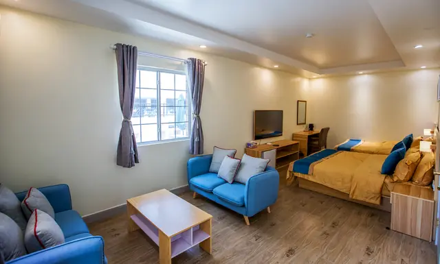 Family Room open-plan seating area with two blue sofas and a coffee table